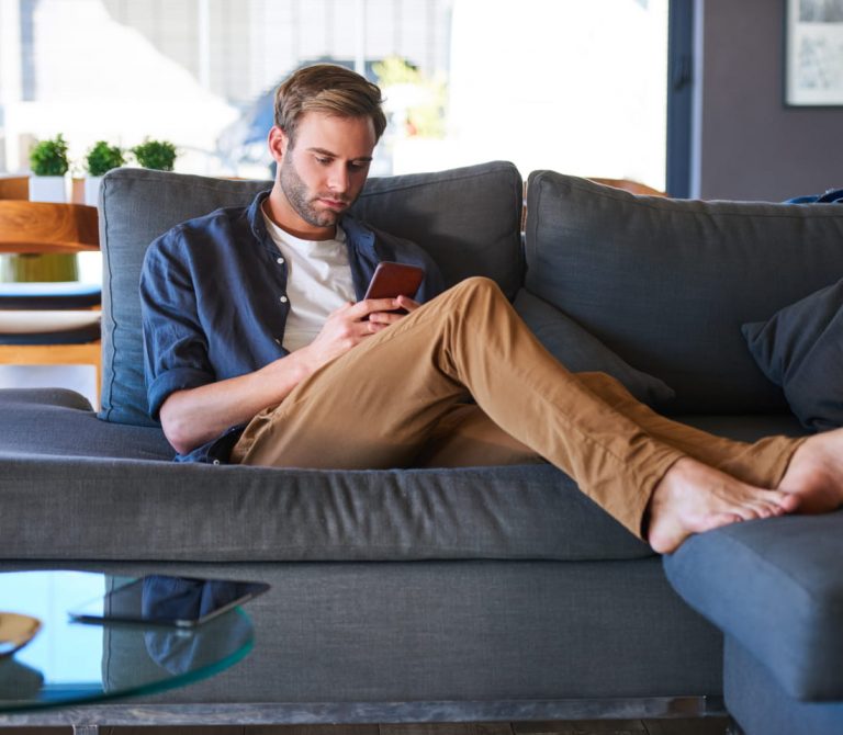 man texting at home